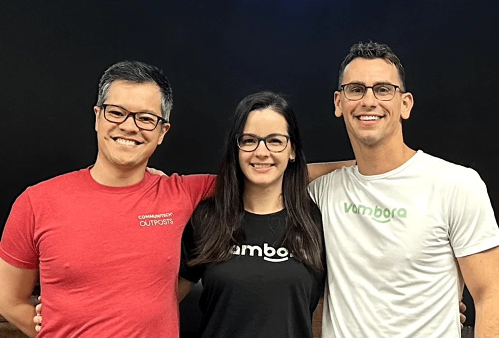 A photograph of three smiling Vambora employees A photograph of three smiling Vambora employees