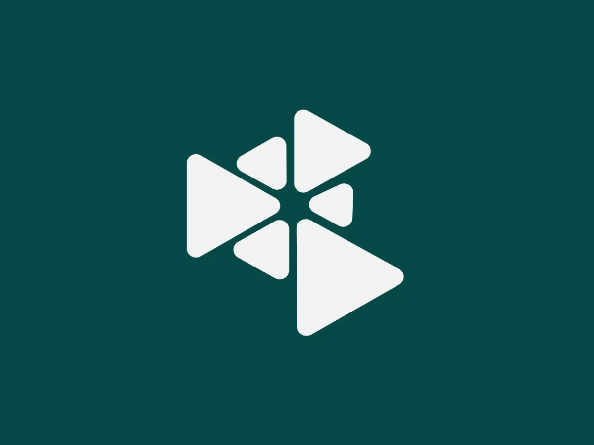 White, interlocking geometric triangles on a teal background, representing seamless global connectivity.